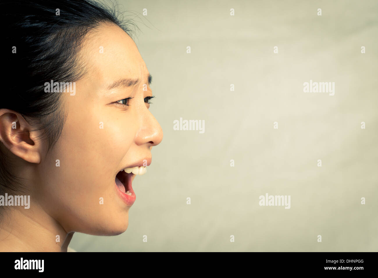 Mujer joven gritando, con tono de moda y antecedentes Foto de stock
