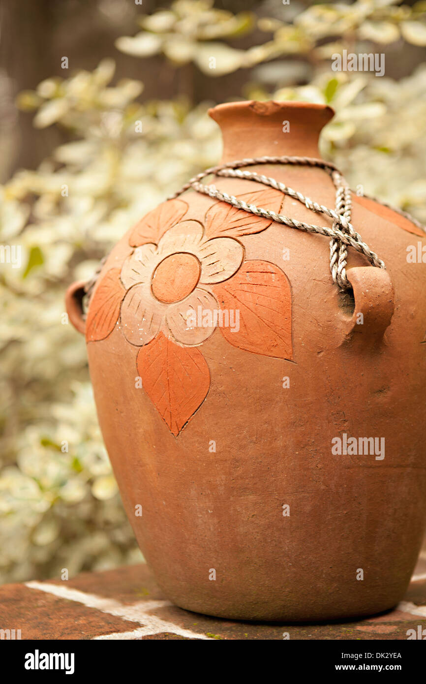 Cierre de flor grabada en la jarra de cerámica terracota Foto de stock