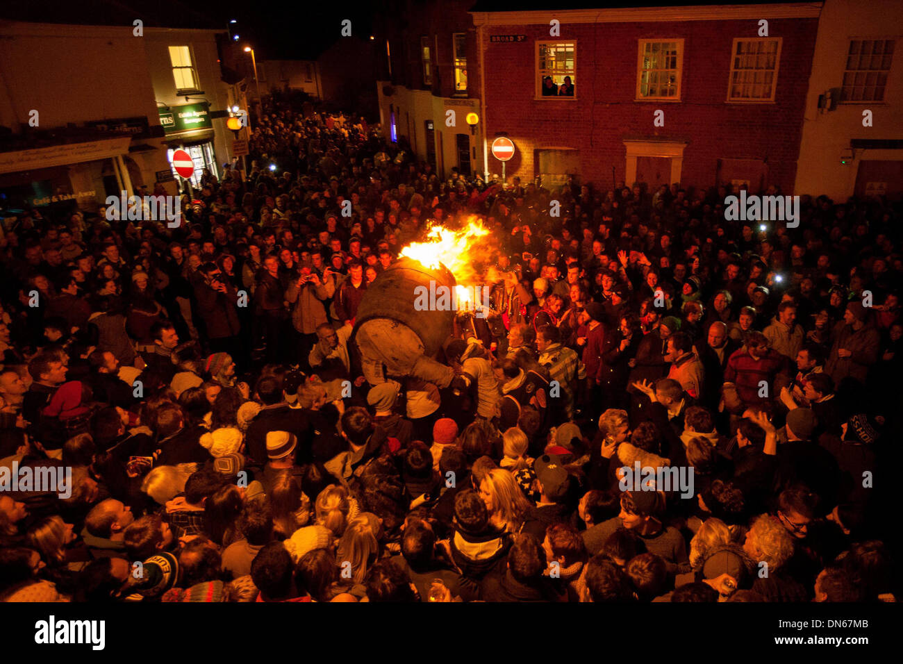 Los participantes se ejecutan con un barril de alquitrán ardiente por las calles de Ottery St Mary, Devon. Foto de stock