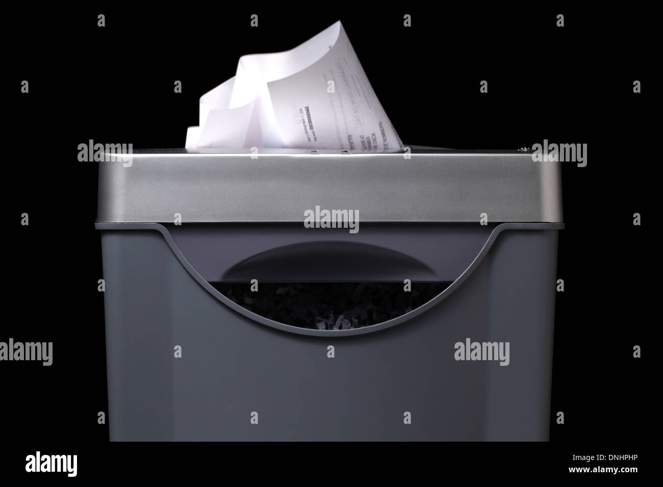 Una vista cercana de una trituradora de papel con papel va por dentro. Foto de stock