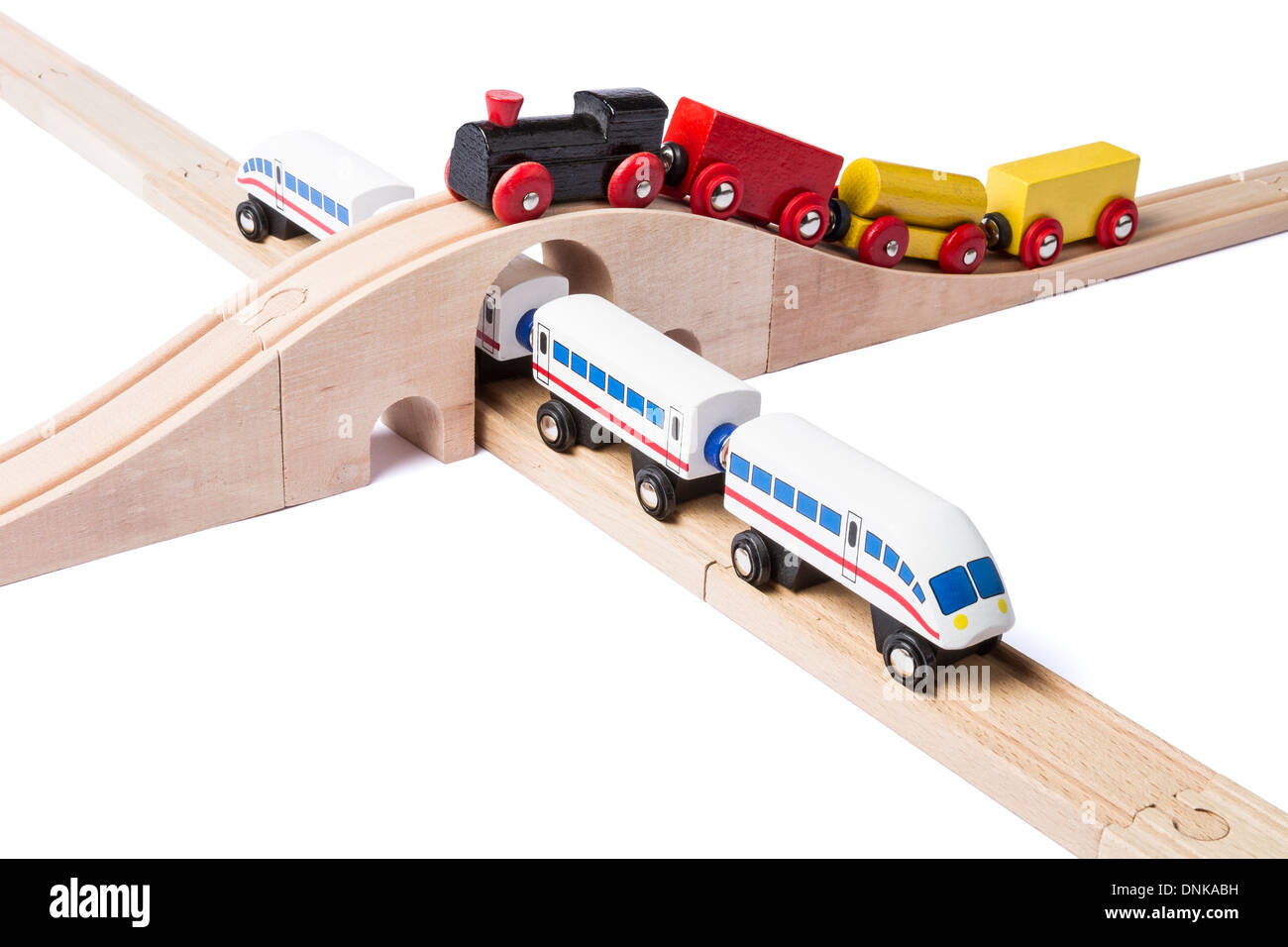 Dos trenes de juguete de madera en vías férreas aislado sobre fondo blanco  Fotografía de stock - Alamy