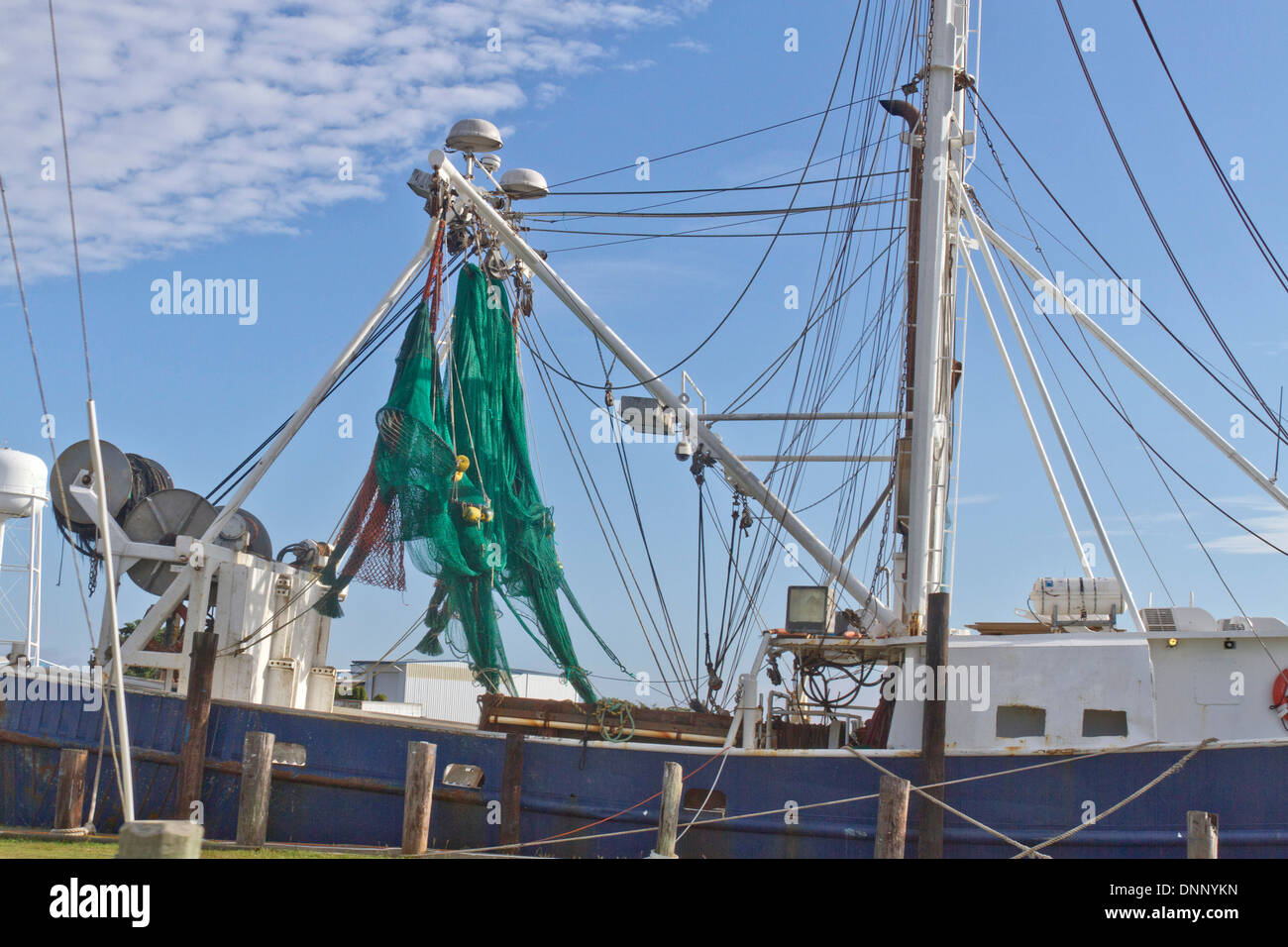 Un arrastrero de pesca comercial con redes de verde Foto de stock