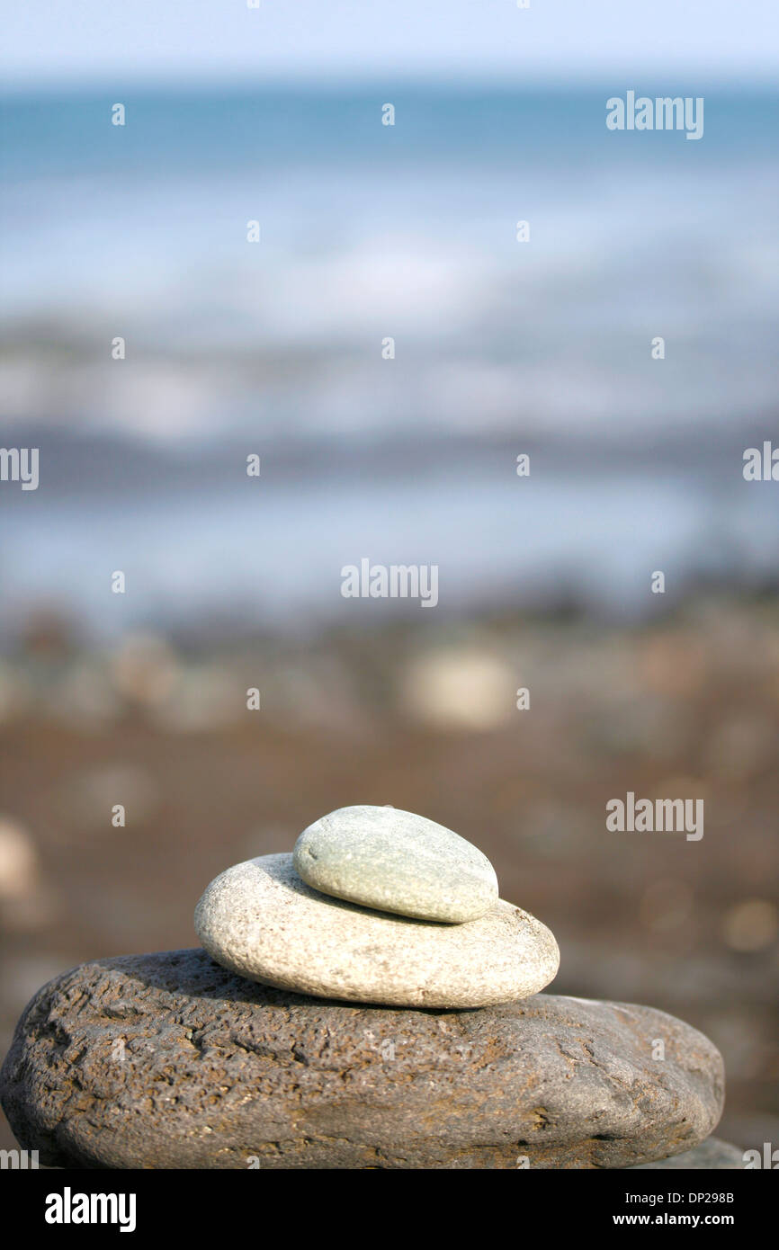 Montón de piedras frente al océano. Foto de stock