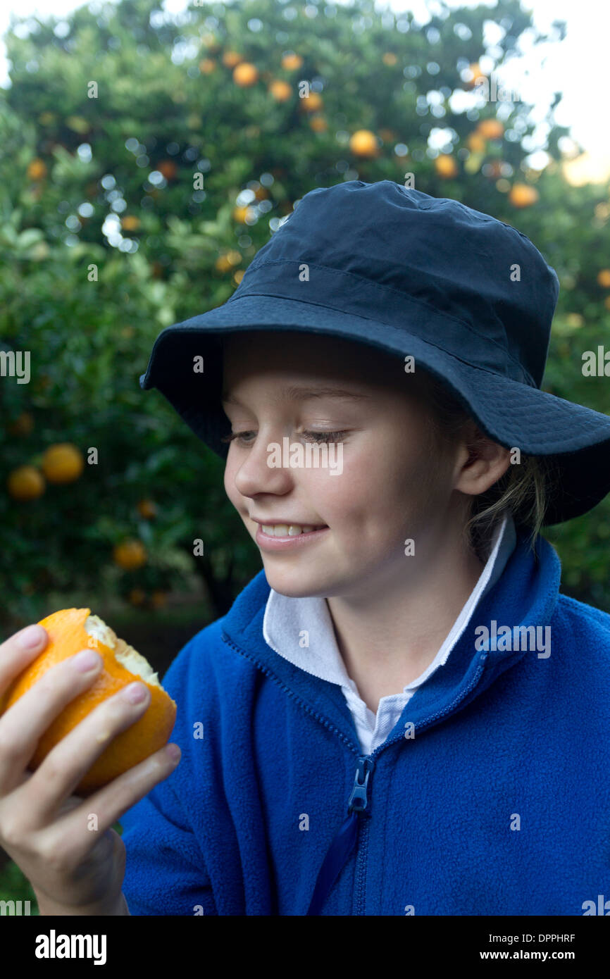 Niña comiendo una naranja fotografías e imágenes de alta resolución - Alamy