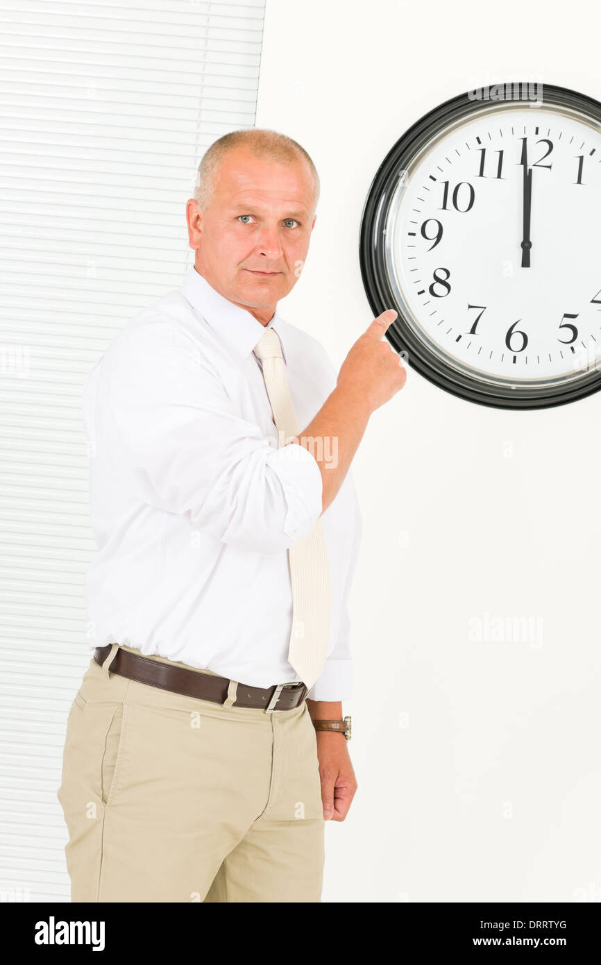Empresario puntual madura en el reloj de punto Foto de stock