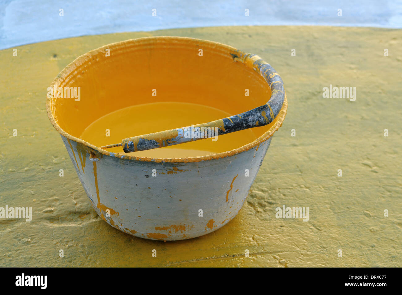 Un balde lleno de acero con pintura de carretera amarilla en una calle de  Cotacachi, Ecuador Fotografía de stock - Alamy