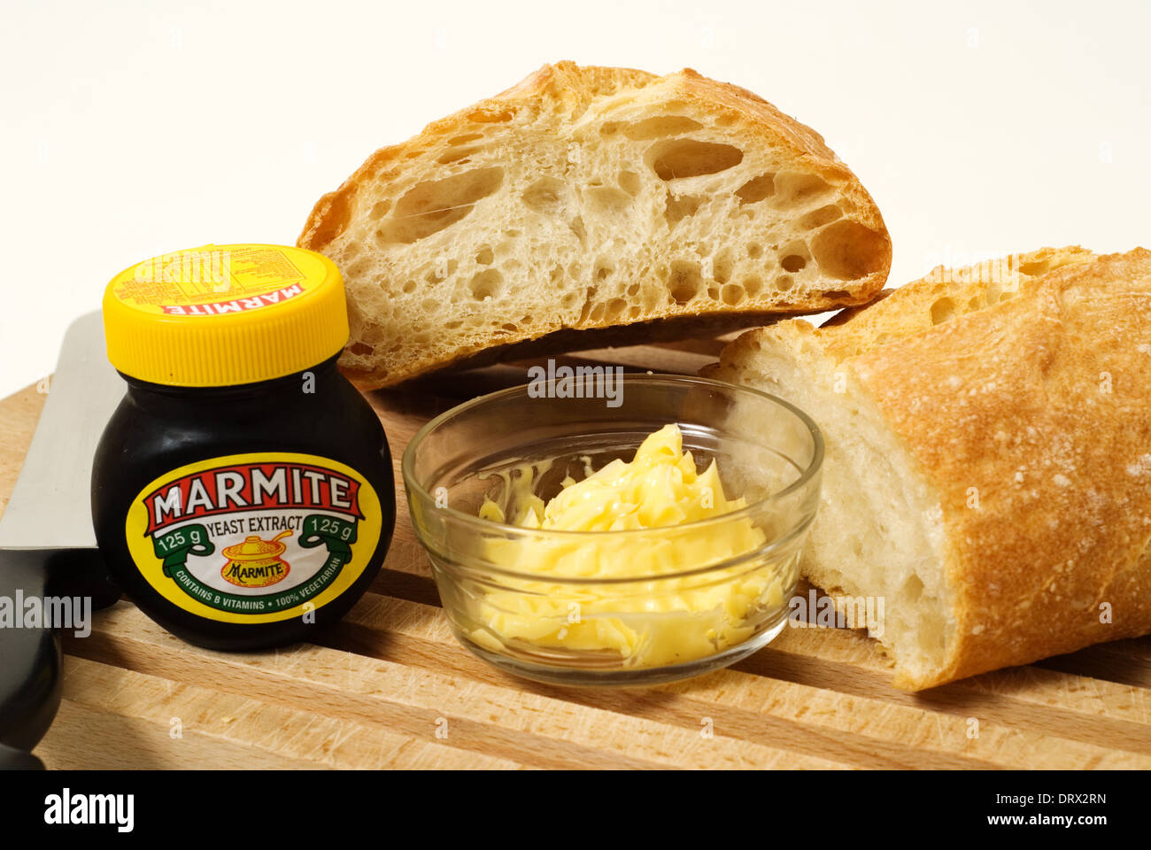 Pan de masa fermentada con mantequilla fresca y marmite jar. Foto de stock