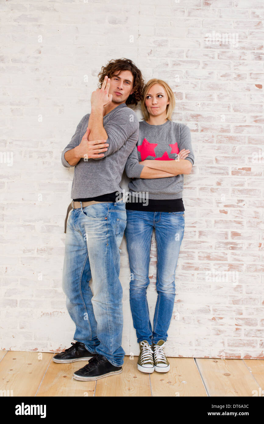 Retrato de estudio de pareja haciendo gestos con la mano la pistola Foto de stock