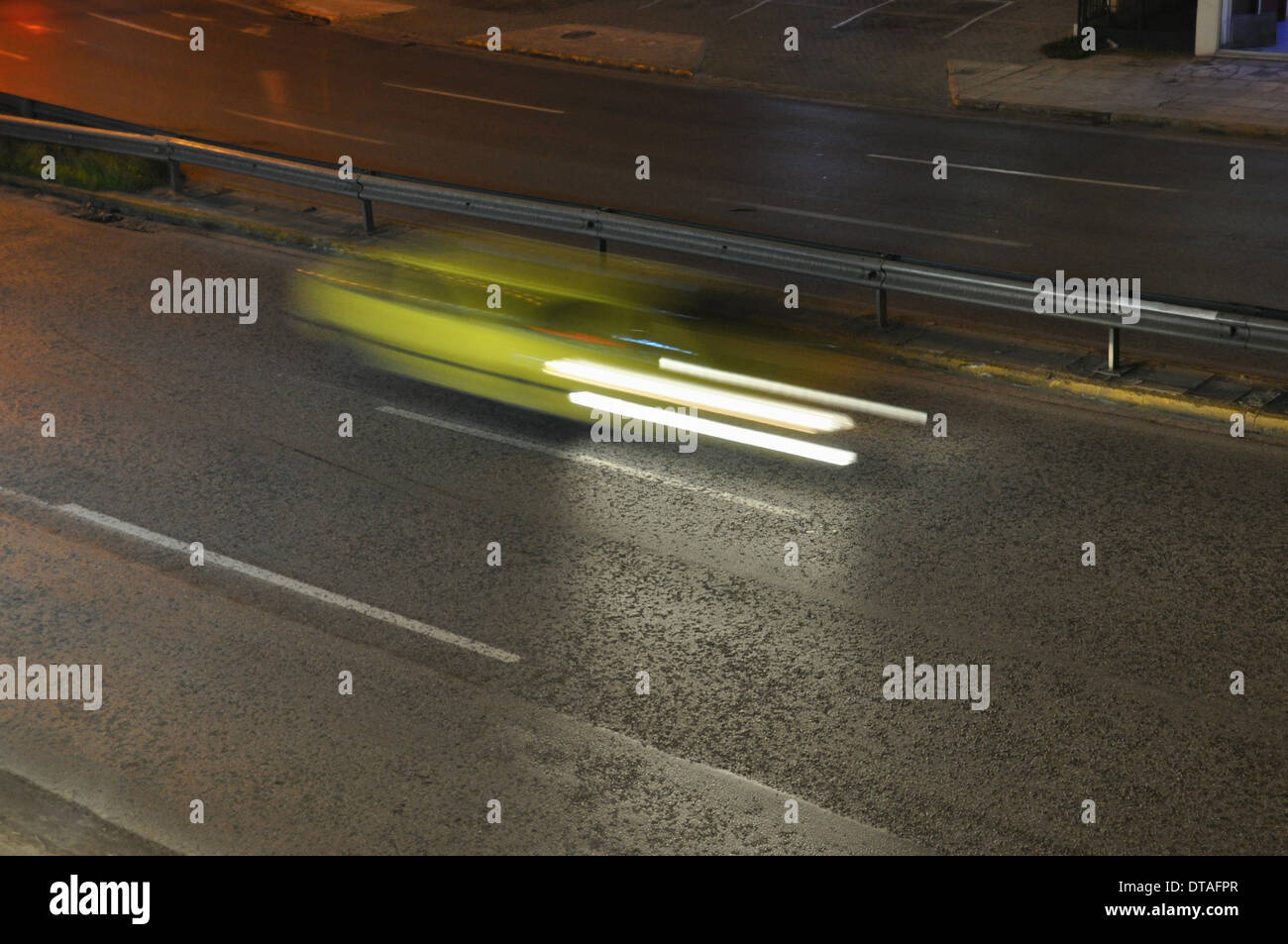 Acelerar el taxi amarillo en la autopista el tráfico en la ciudad por la noche. Desenfoque de movimiento. Foto de stock