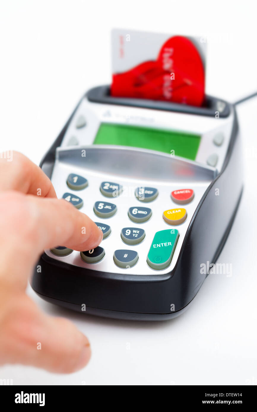 Close-up de un hombre mano introduciendo el número en una máquina con chip y PIN. El enfoque selectivo en la parte delantera de la máquina. Foto de stock
