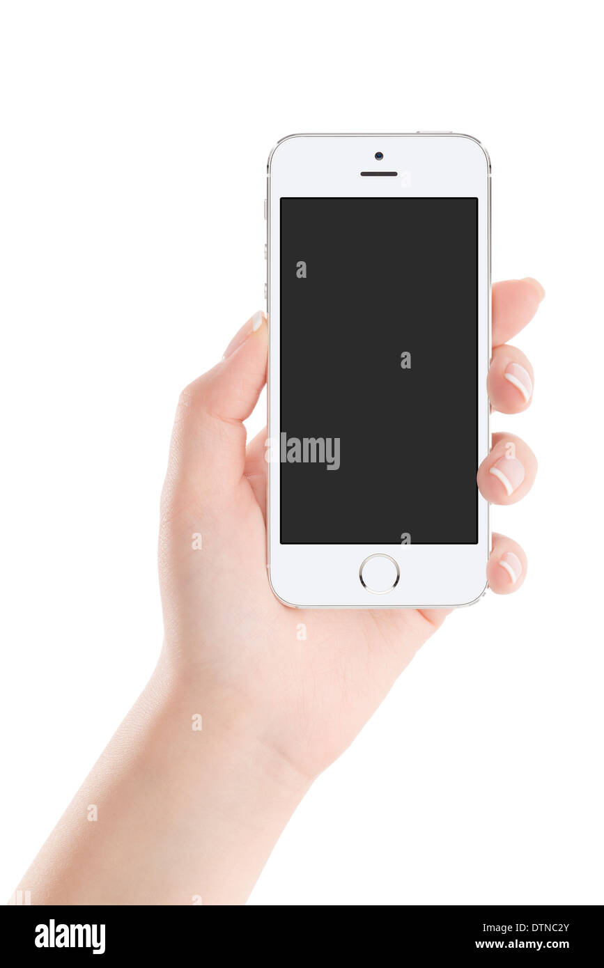 Mano femenina holding móvil blanco y moderno teléfono inteligente con pantalla en blanco aislado sobre fondo blanco. Alta calidad. Foto de stock