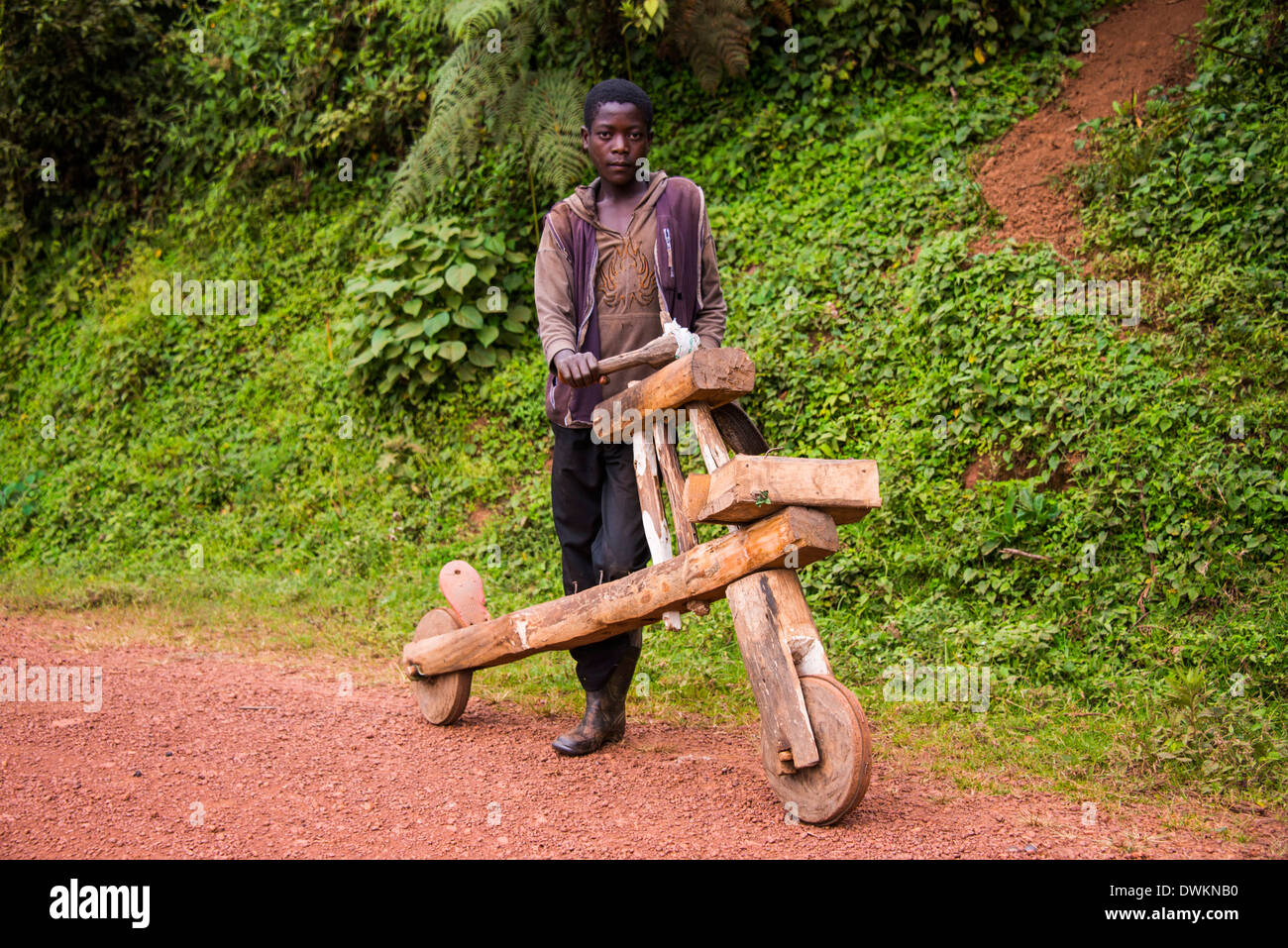 Niño con su propia bicicleta hecha exclusivamente de madera, en el sur de Uganda, África oriental, África Foto de stock