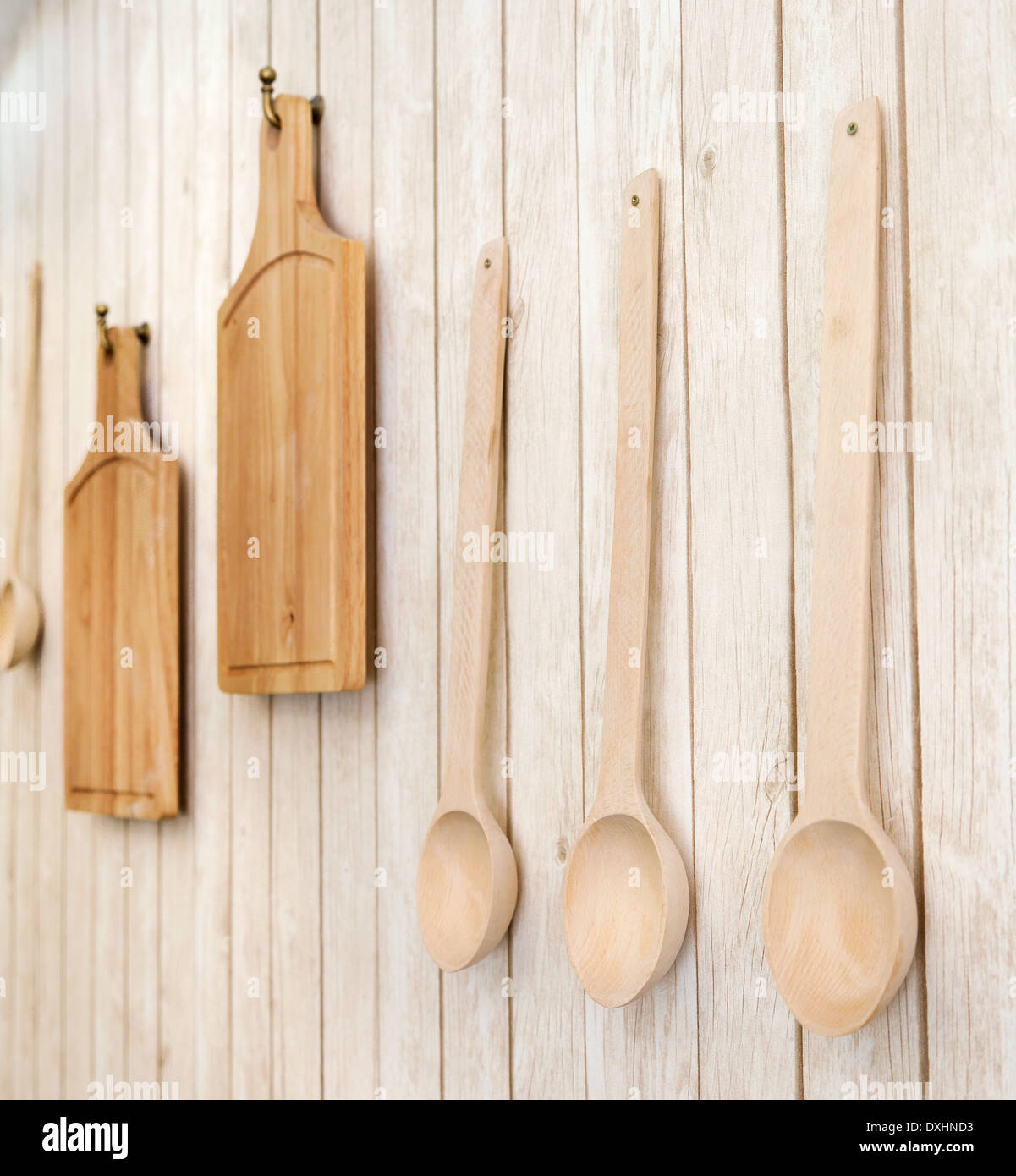 Las tablas de cortar y cucharas de madera colgadas en la pared, utensilios  de cocina, se centran en las cucharas Fotografía de stock - Alamy