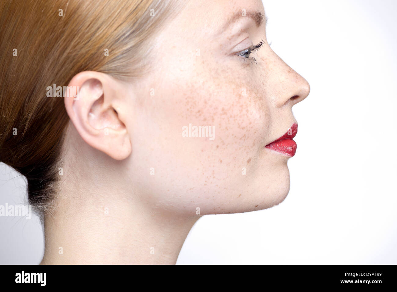 Joven mujer vistiendo los labios rojos, perfil Foto de stock
