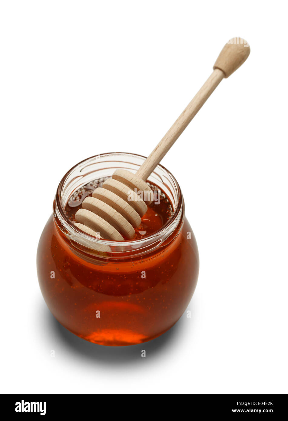 Tarro de miel con Stir Stick aislado sobre fondo blanco. Foto de stock
