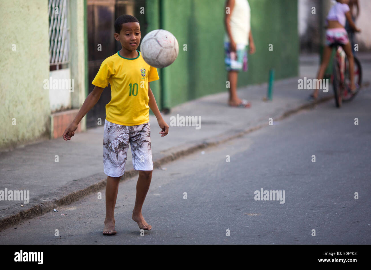 Muchachos jugando al fútbol brasileño en una calle en las favelas de Río de Janeiro. Foto de stock