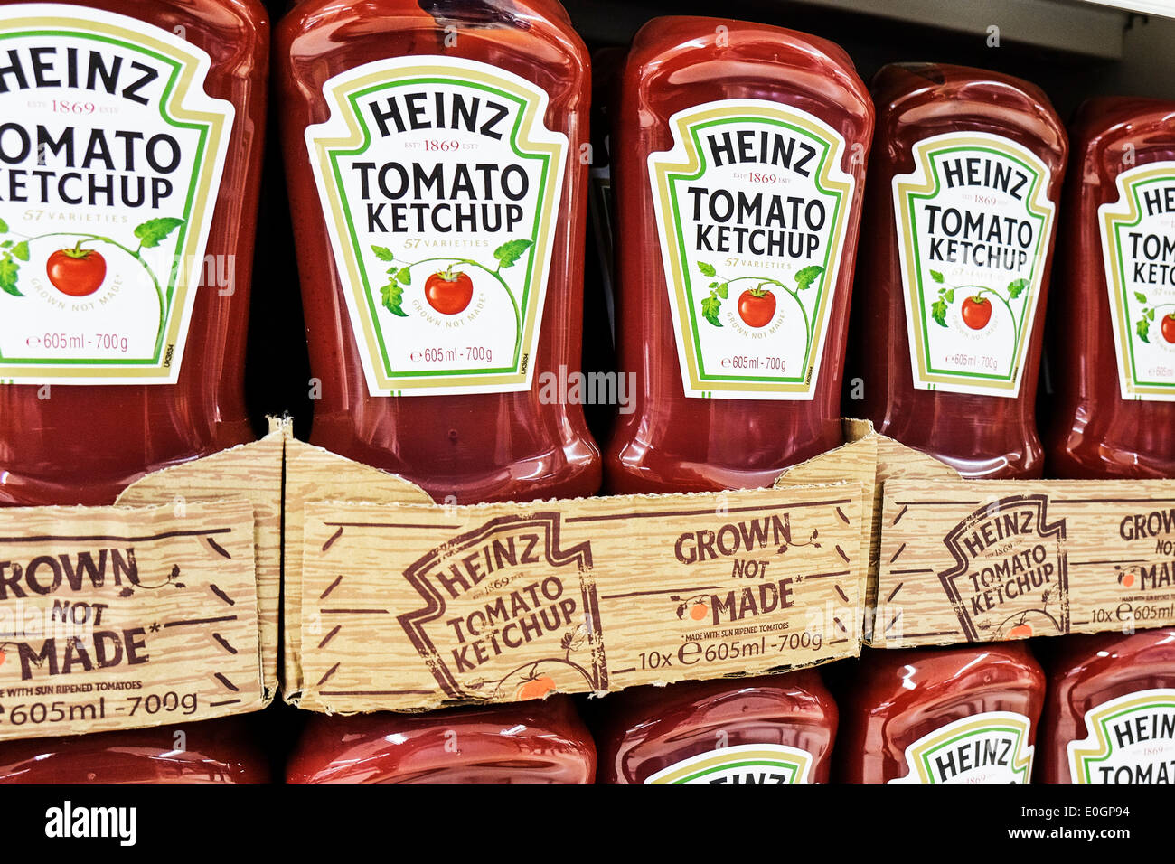 Contenedores de Ketchup Heinz en la pantalla en un supermercado Tesco. Foto de stock