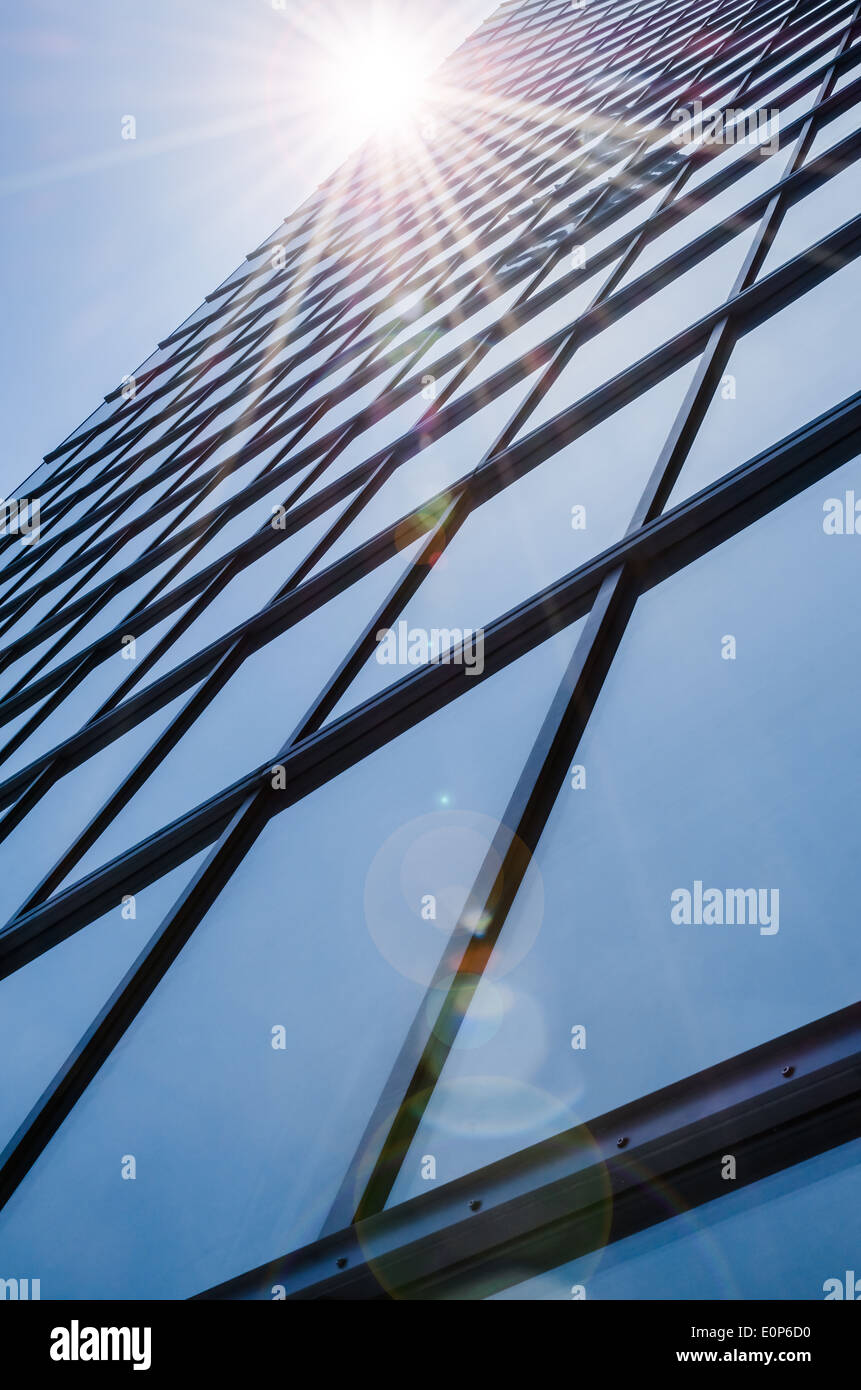 Vidrio y acero - fachada simétrica de modernos rascacielos con resplandor reflejo Foto de stock