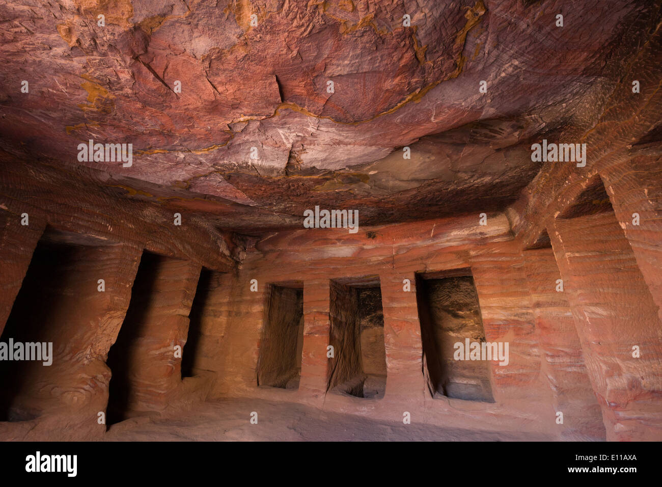 Interior de una tumba labrada en la calle de fachadas, mostrando las formaciones de roca, Petra, Jordania Foto de stock