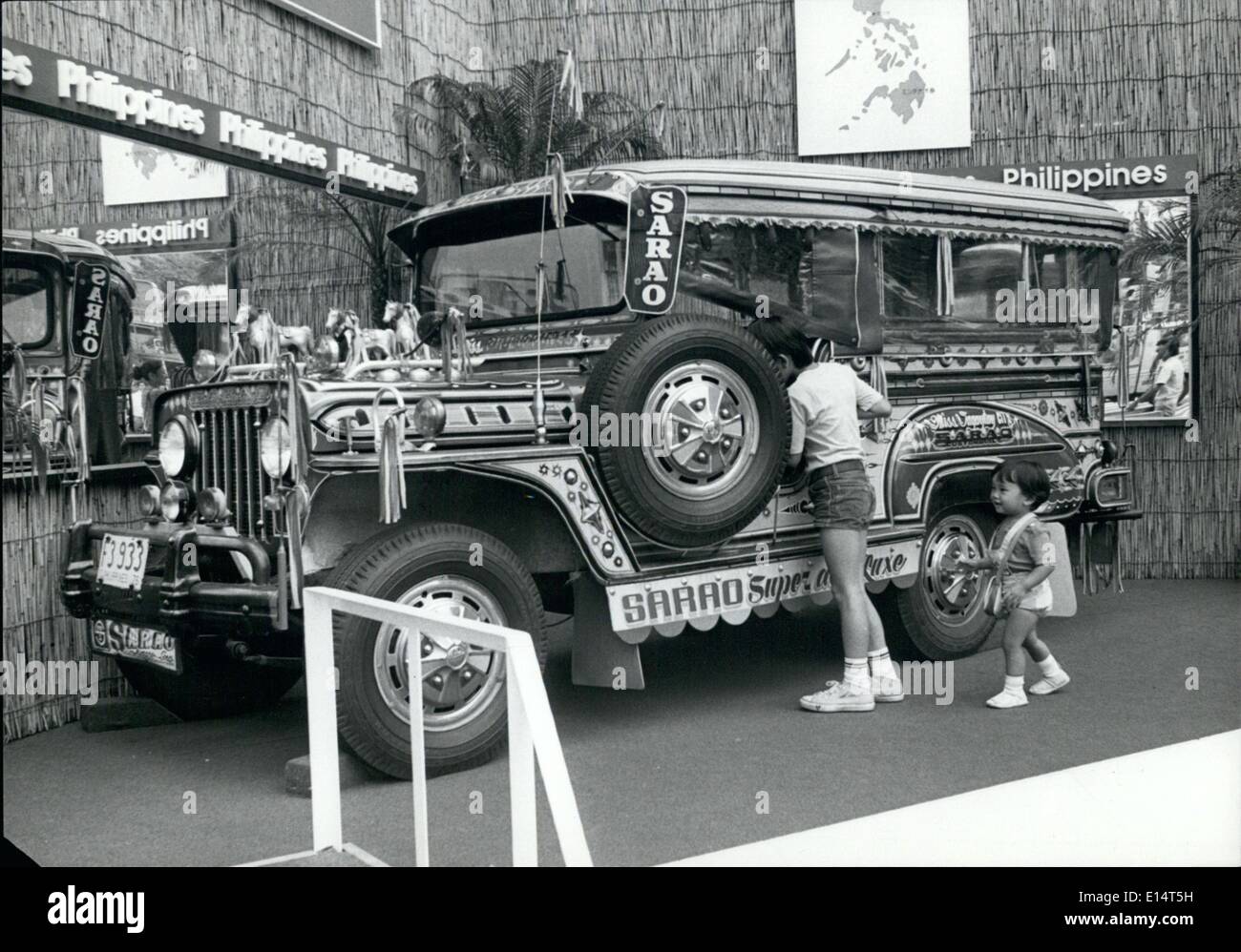 Abril 18, 2012 - Philippine ''Taxi'' muestra en Tokio : Uno de los mucho decorado ''Filipinas Jeepneys'' que son el medio de transporte popular en Manila, y a través de las islas Filipinas se encuentra en exhibición en la calle Ginza de Tokio con el fin de atraer turistas Japoneses. Los coloridos vehículos actúan como buses, y llevar a una docena o más pasajeros en las tarifas baratas. La ''Jeepney'' propietarios compiten unos con los otros para adornar sus vehículos para hacerlos atractivos y admirado por los pasajeros. La foto muestra a dos jóvenes muchachos de Tokio obtener un vistazo de cerca a las ''Jeepney' Foto de stock