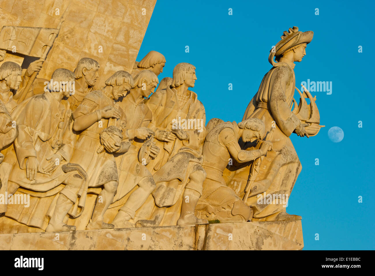 El Monumento de los descubrimientos tallas de primeros navegantes diurna, con luna Belem Lisboa Portugal Europa occidental Foto de stock