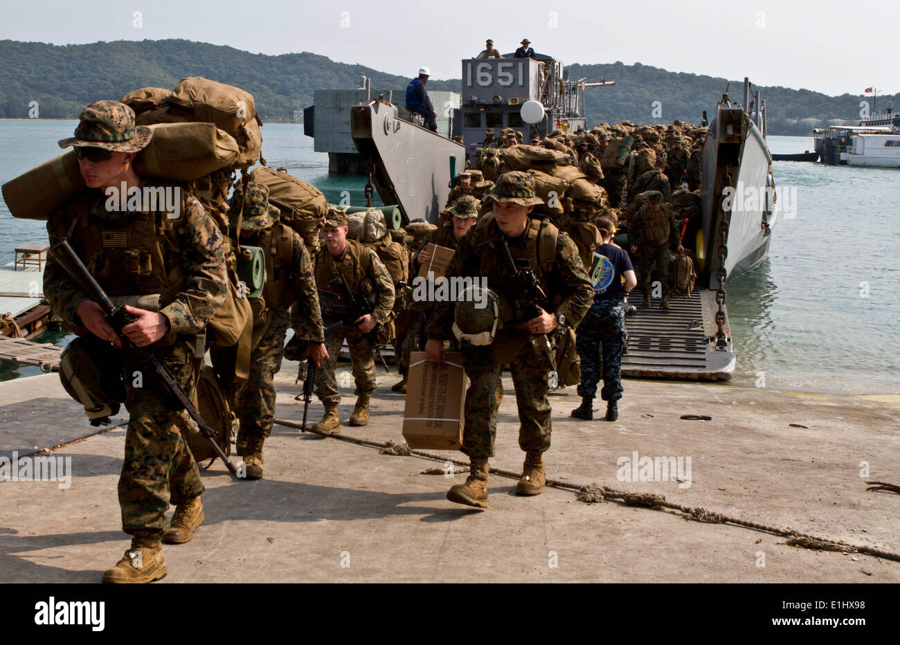 Marines y marineros, con la 31ª Unidad Expedicionaria de los Infantes de Marina paso off Landing Craft, utilidad (LCU) 1651 asignado a Amphibi Foto de stock