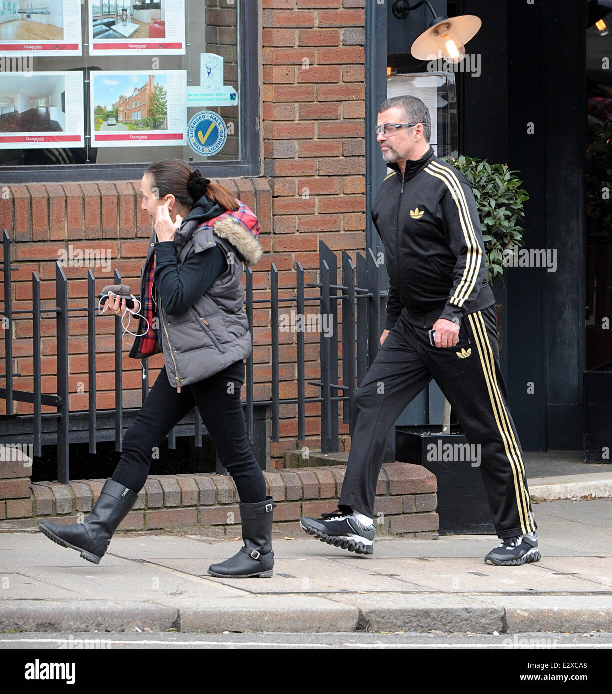 George Michael y un amigo salir Cote Brasserie en norte Londres después de almorzar. George viste un chándal Adidas negro con franjas de oro. Featuring: Michael donde: Londres