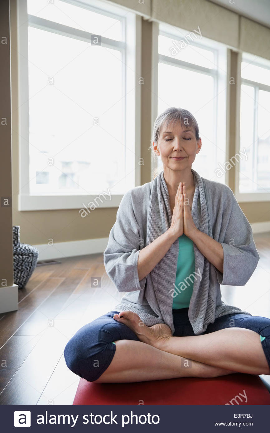 Mujer meditando en el salón Foto de stock