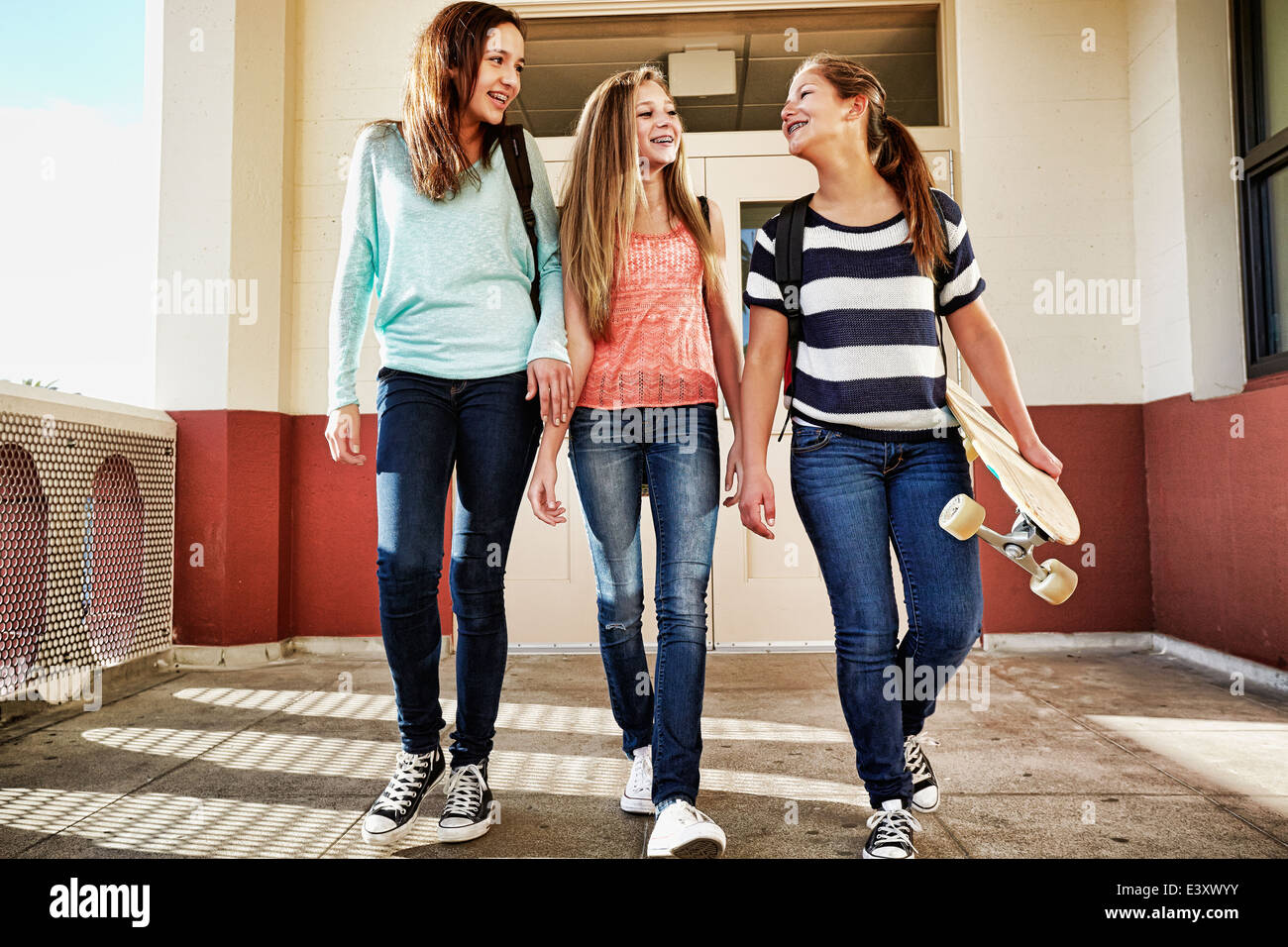 Las adolescentes caminando por el campus de la escuela Foto de stock