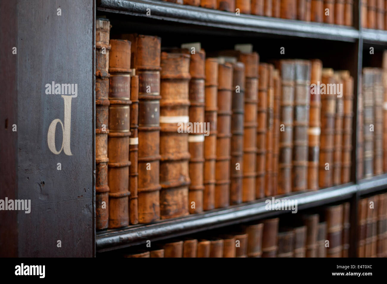 Estantes de libros con los libros históricos en el Trinity College Library "Long Room", Dublín, Irlanda Foto de stock