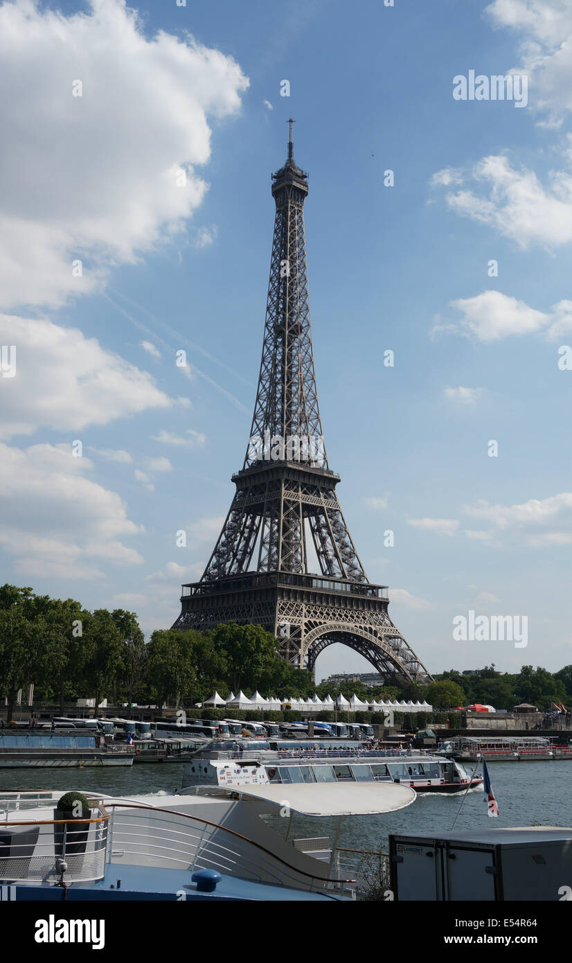 Botes de paseo por el río Sena, pasando por la Torre Eiffel, con una cuidada aldea blanca de los vendedores de tiendas ayudando a mostrar a tamaño real de la torre Foto de stock
