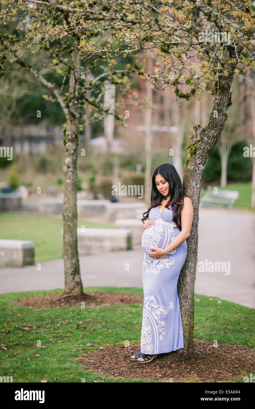 Mujer Asiática sosteniendo su embarazada vientre Foto de stock