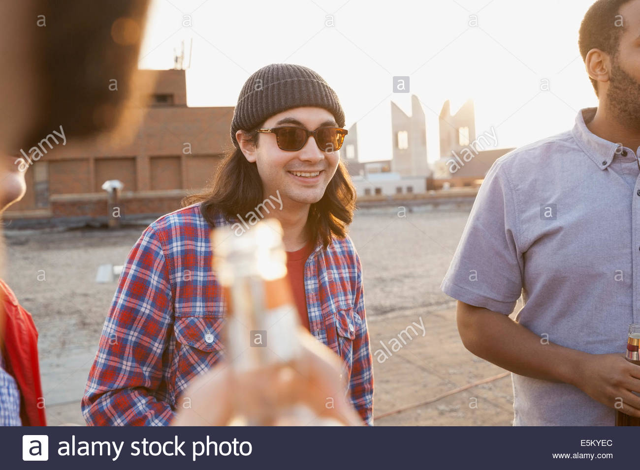 Amigos bebiendo cerveza en parte de la azotea Foto de stock