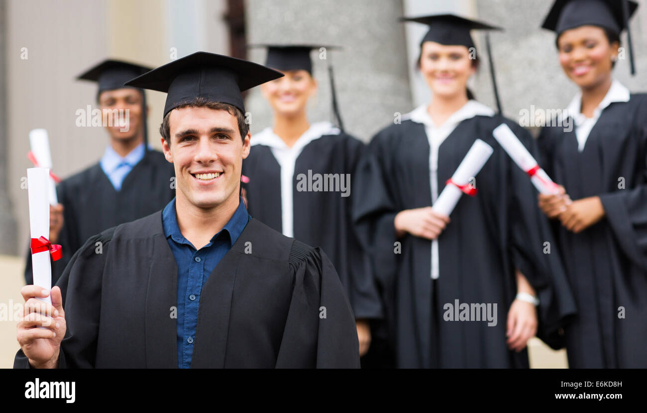Handsome male university graduate holding fotografías e imágenes de alta resolución imagen
