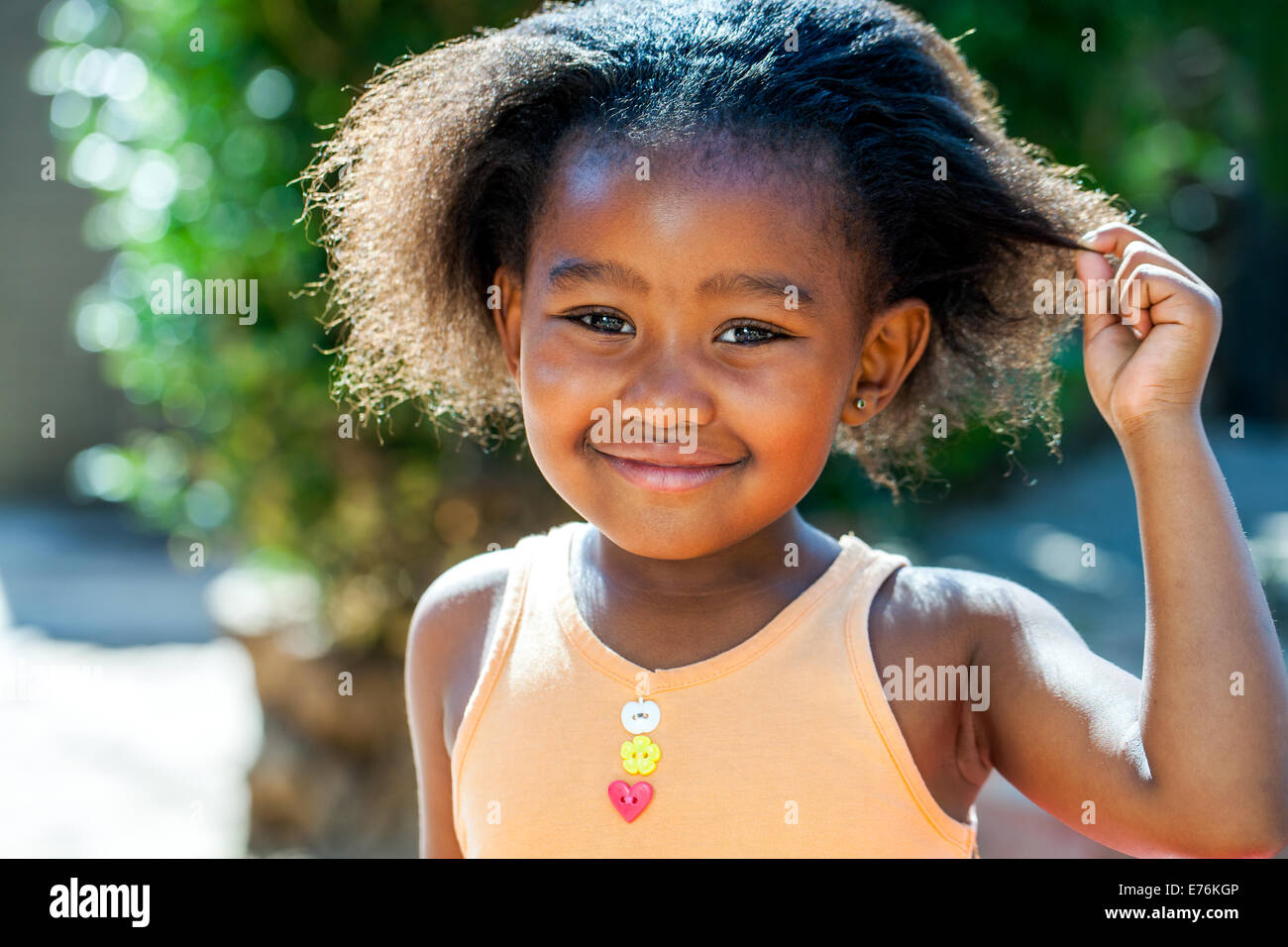 Close Up retrato de pequeña muchacha africana mostrando el peinado. Foto de stock