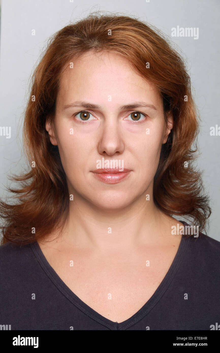 Joven mujer caucásica closeup retrato. Headshot sobre gris Foto de stock