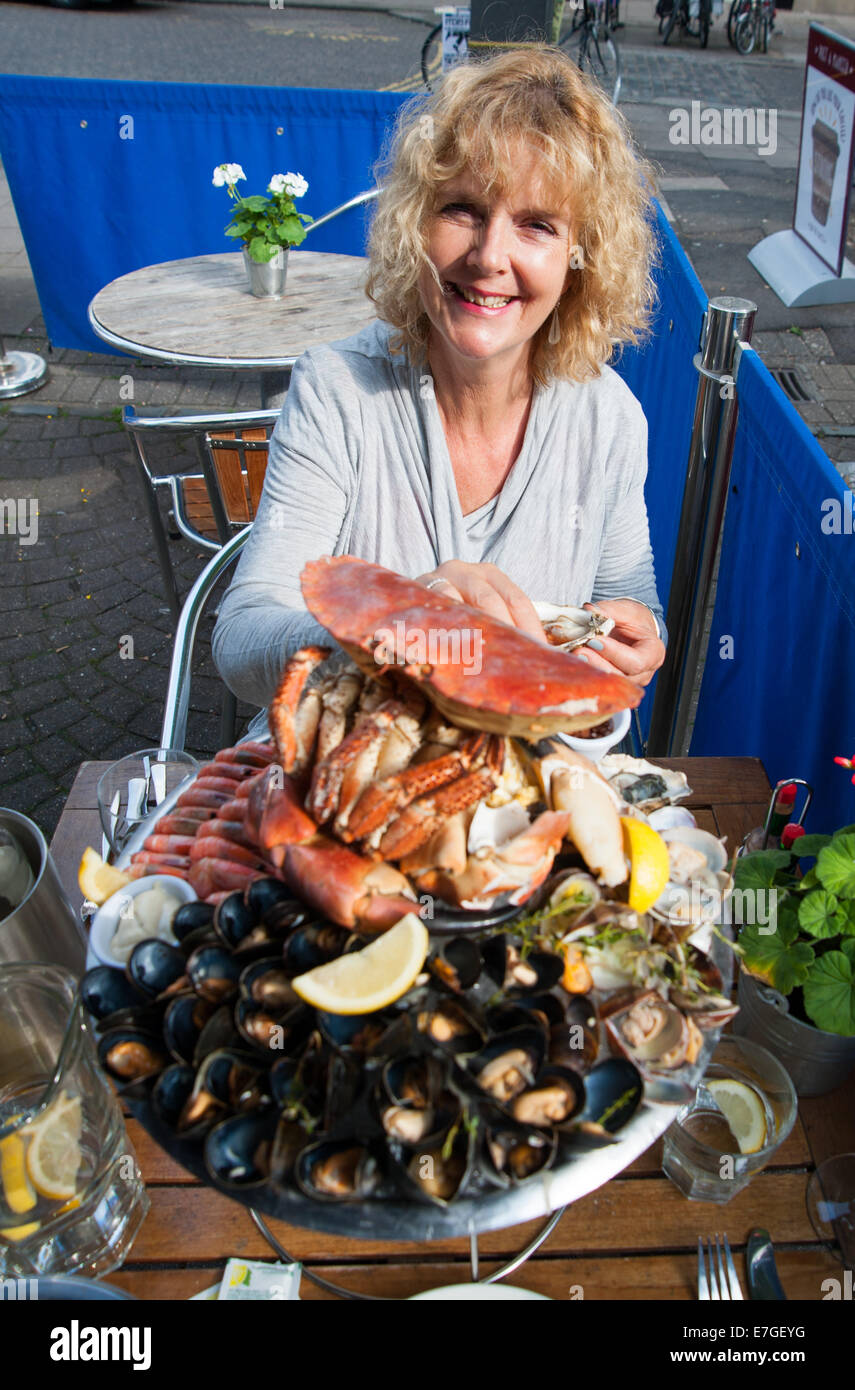 Mujer comiendo un plateau de fruits de mer con cangrejo fresco o un plato de mariscos frescos en el restaurante Brighton Reino Unido Fishy Fishy Foto de stock