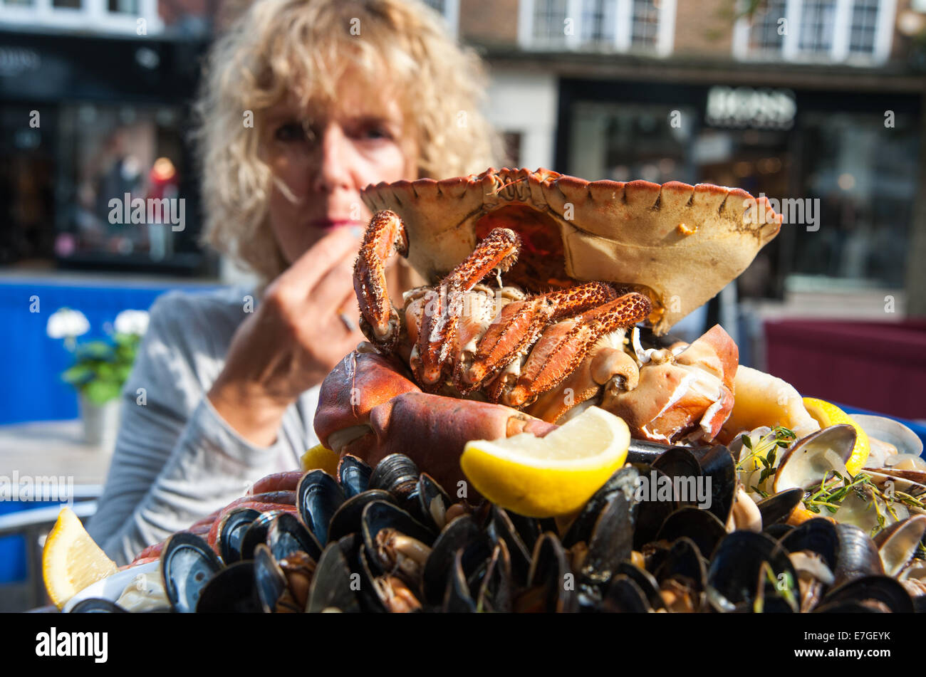 Mujer comiendo un plateau de fruits de mer con cangrejo fresco o un plato de mariscos frescos en el restaurante Brighton Reino Unido Fishy Fishy Foto de stock