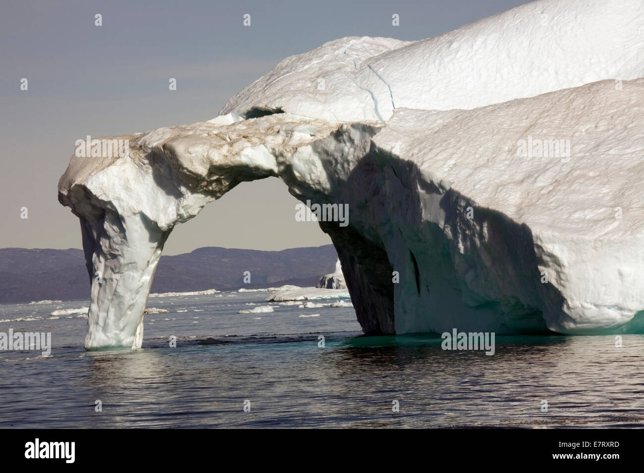 Un arco delicado de hielo se derrumba de un gigantesco iceberg desencajado del glaciar Sermeq Kujalleq (Glaciar Jacobshavn) Foto de stock