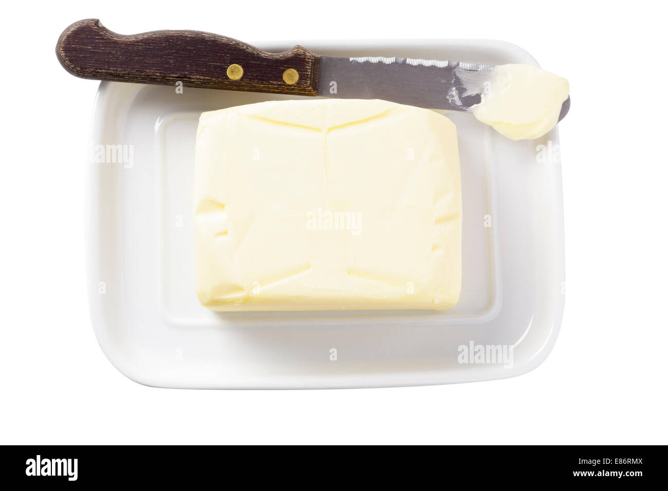 La mantequilla en el recipiente con la cuchilla Foto de stock