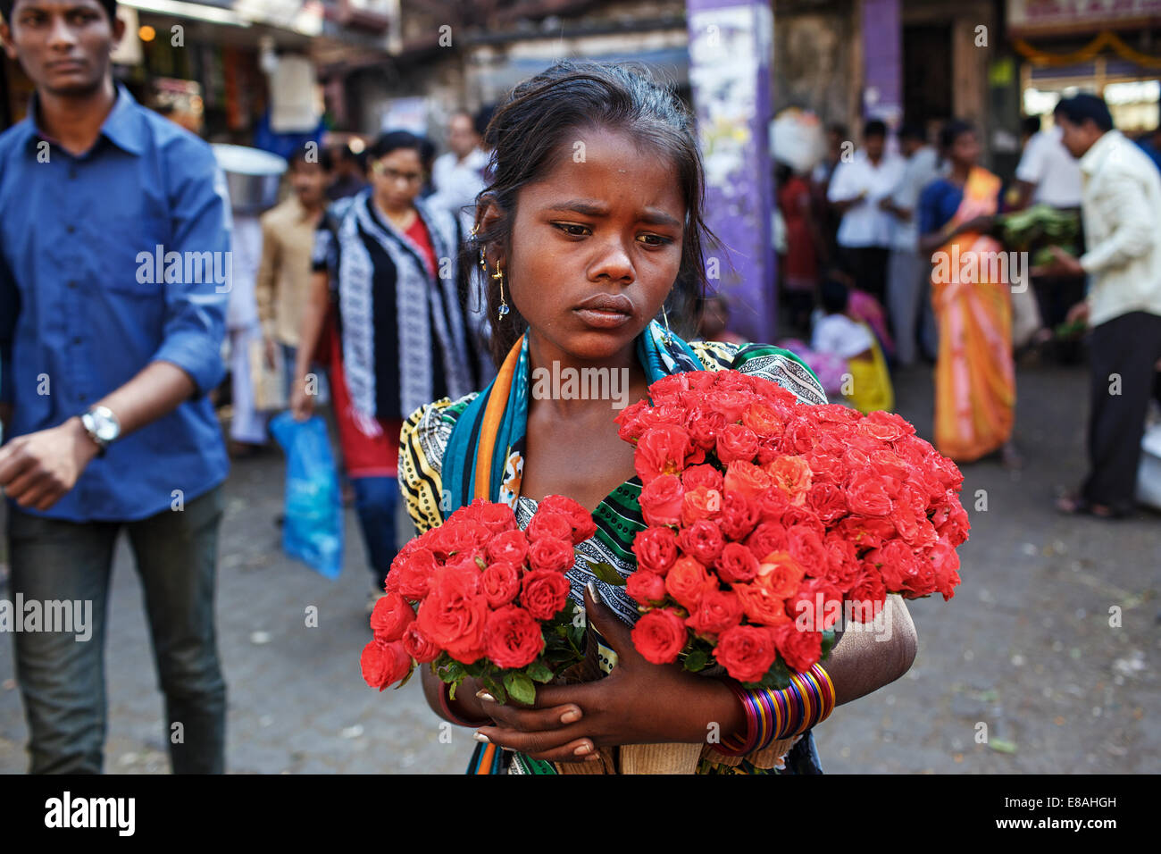 Una niña vendiendo flores fuera de Estación de Trenes de Dadar en Mumbai, India. Foto de stock