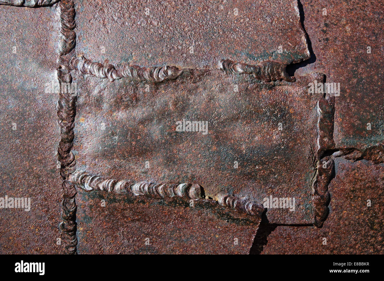 Antiguo soldado parcheado oxidados y metal corroído textura de fondo Foto de stock