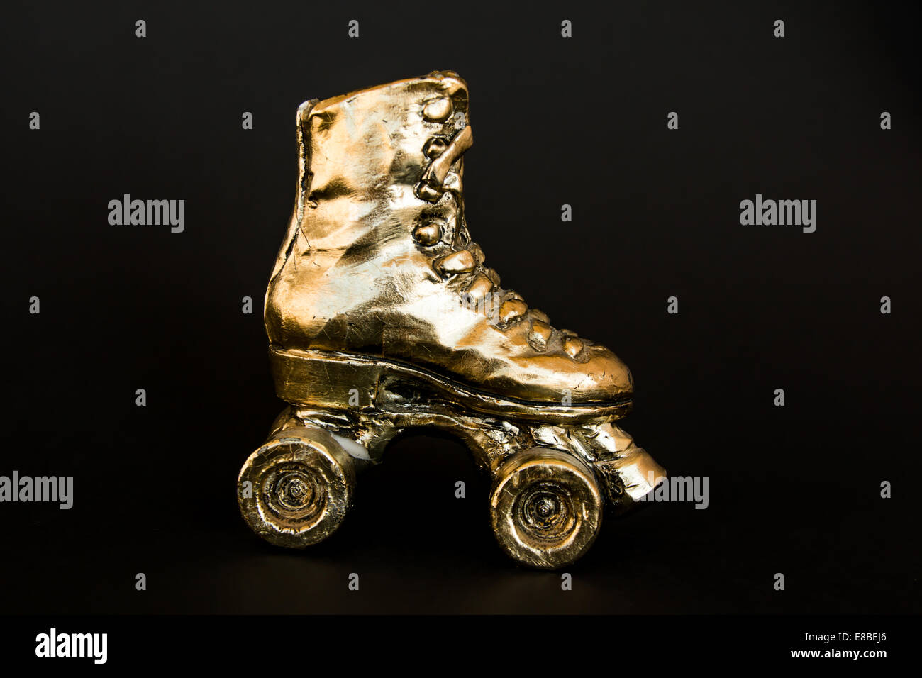 Patines de oro con tacón alto aislado contra fondo negro Fotografía de  stock - Alamy