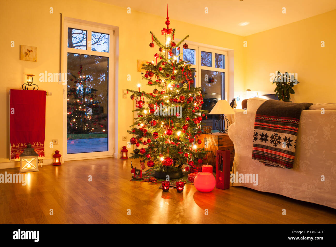 Árbol de Navidad iluminado con velas en casa en alemán Foto de stock