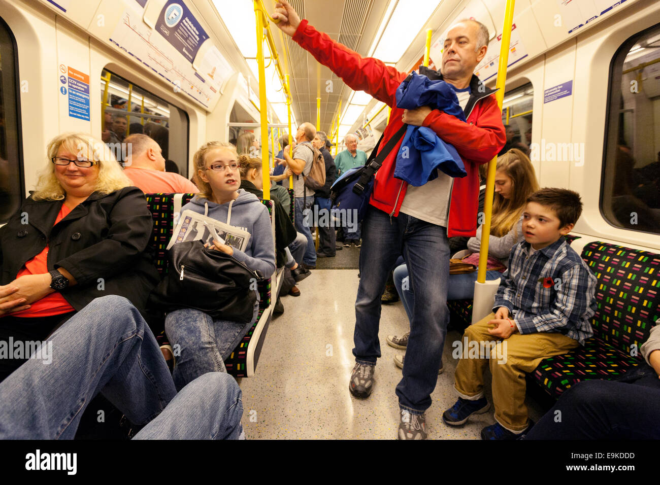 Familias con niños que viajan en un vagón en un tren subterráneo de Londres, Londres, Reino Unido Foto de stock