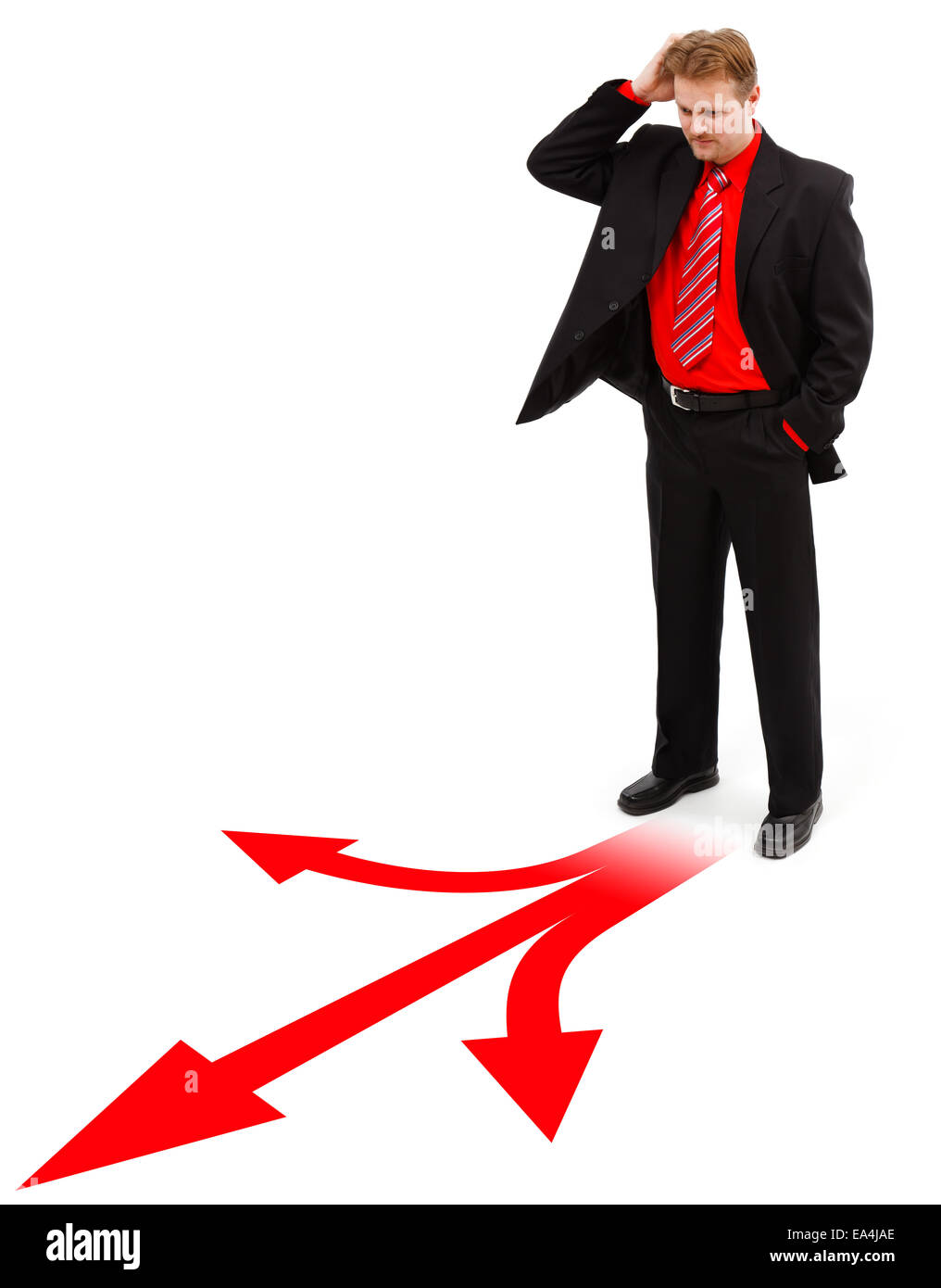 Hombre de pie delante de las decisiones se muestra por las flechas rojas Foto de stock