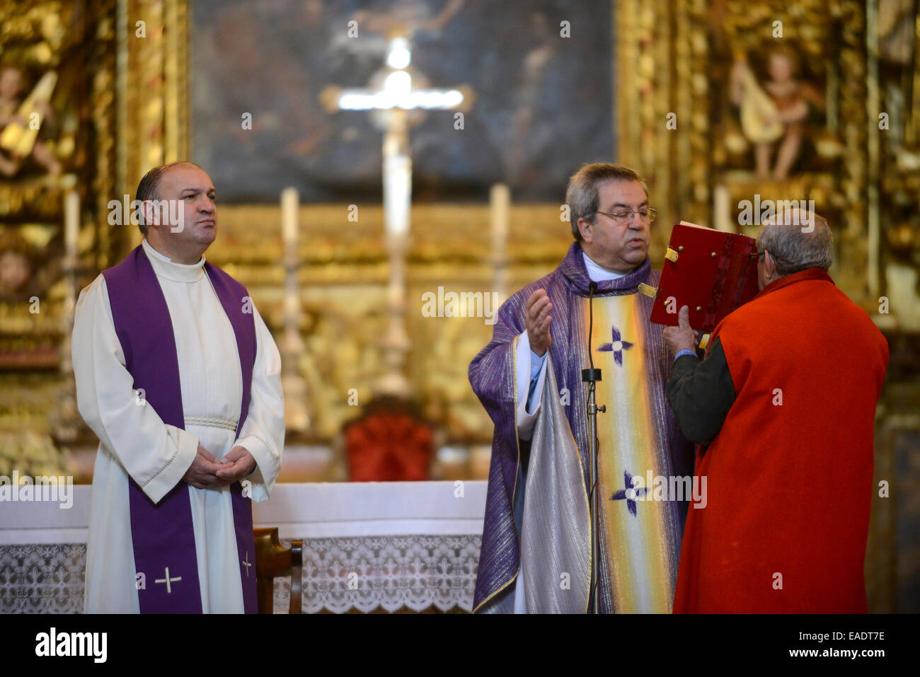 Sacerdote lectura de la Biblia durante la celebración de la misa católica Foto de stock