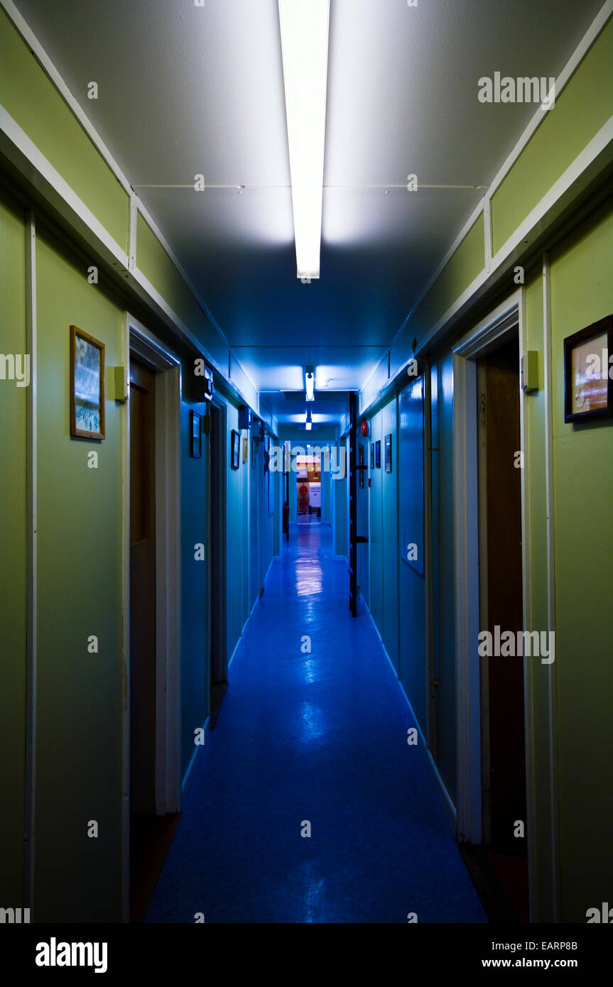 Espeluznante iluminación fluorescente azul en un pasillo de una estación de investigación. Foto de stock