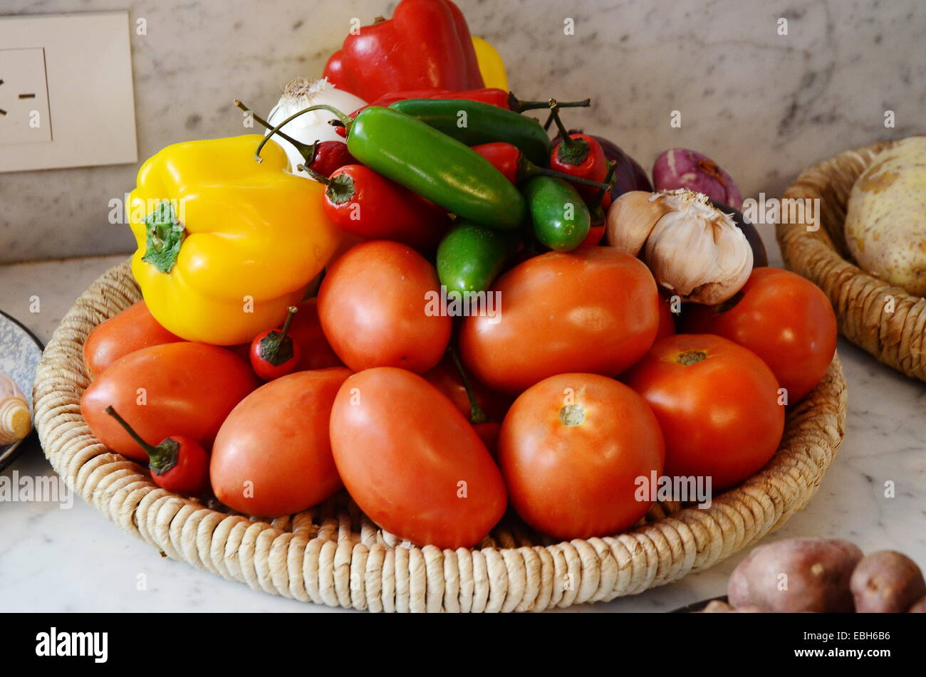 El rojo, el amarillo y el chile jalapeño con tomates, ajos y cebollas. Foto de stock