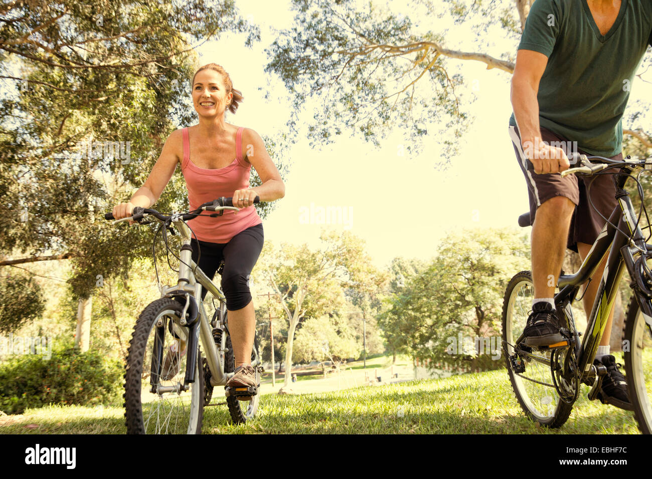 Pareja madura el ciclismo a través de park Foto de stock